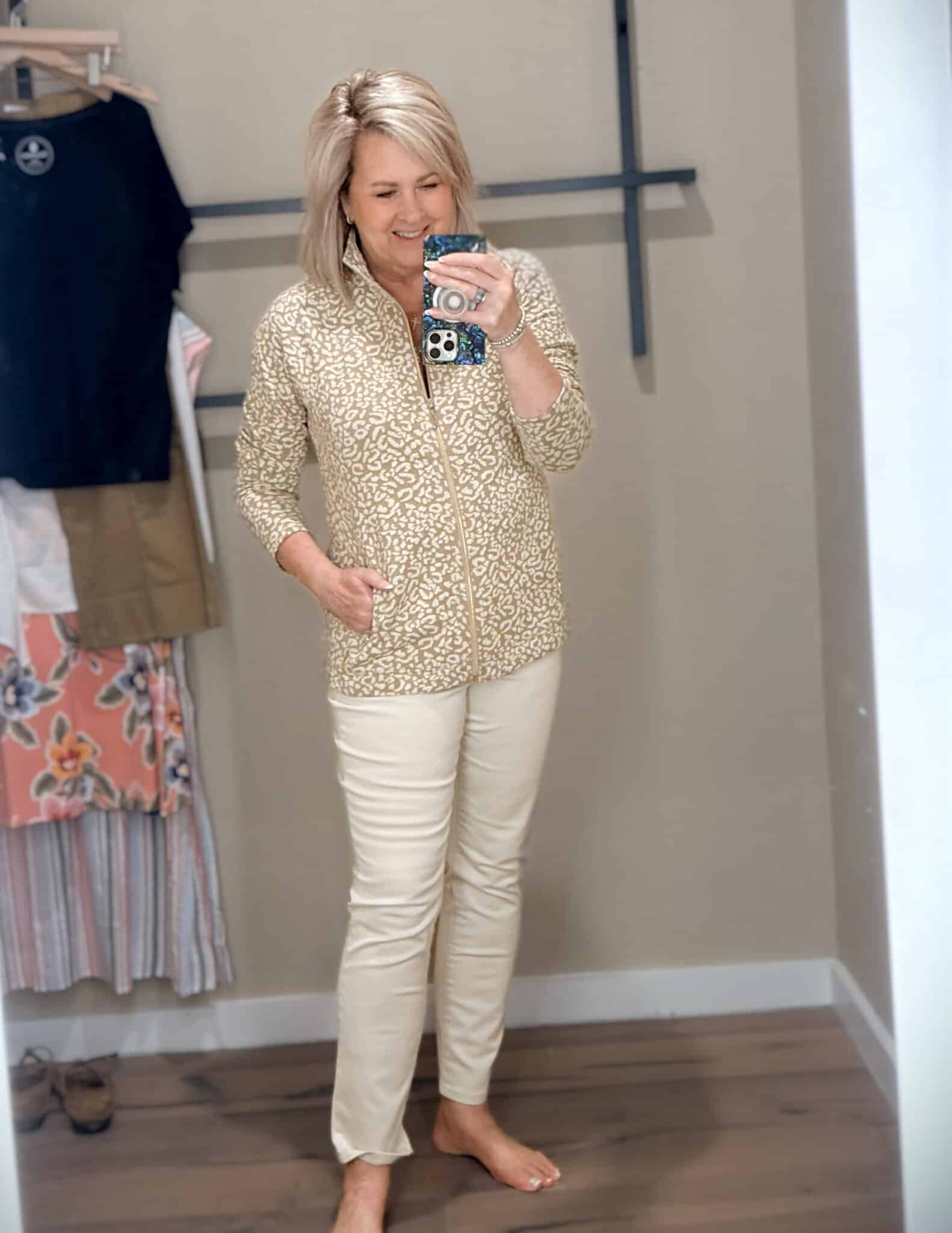 Tania wearing a leopard print 1/4 zip sweatshirt and ivory jeans from Tommy Bahama