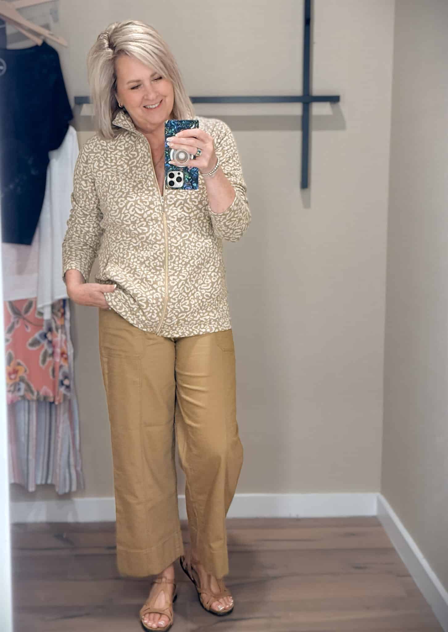 Tania wearing a leopard print 1/4 zip sweatshirt and caramel crop pants from Tommy Bahama