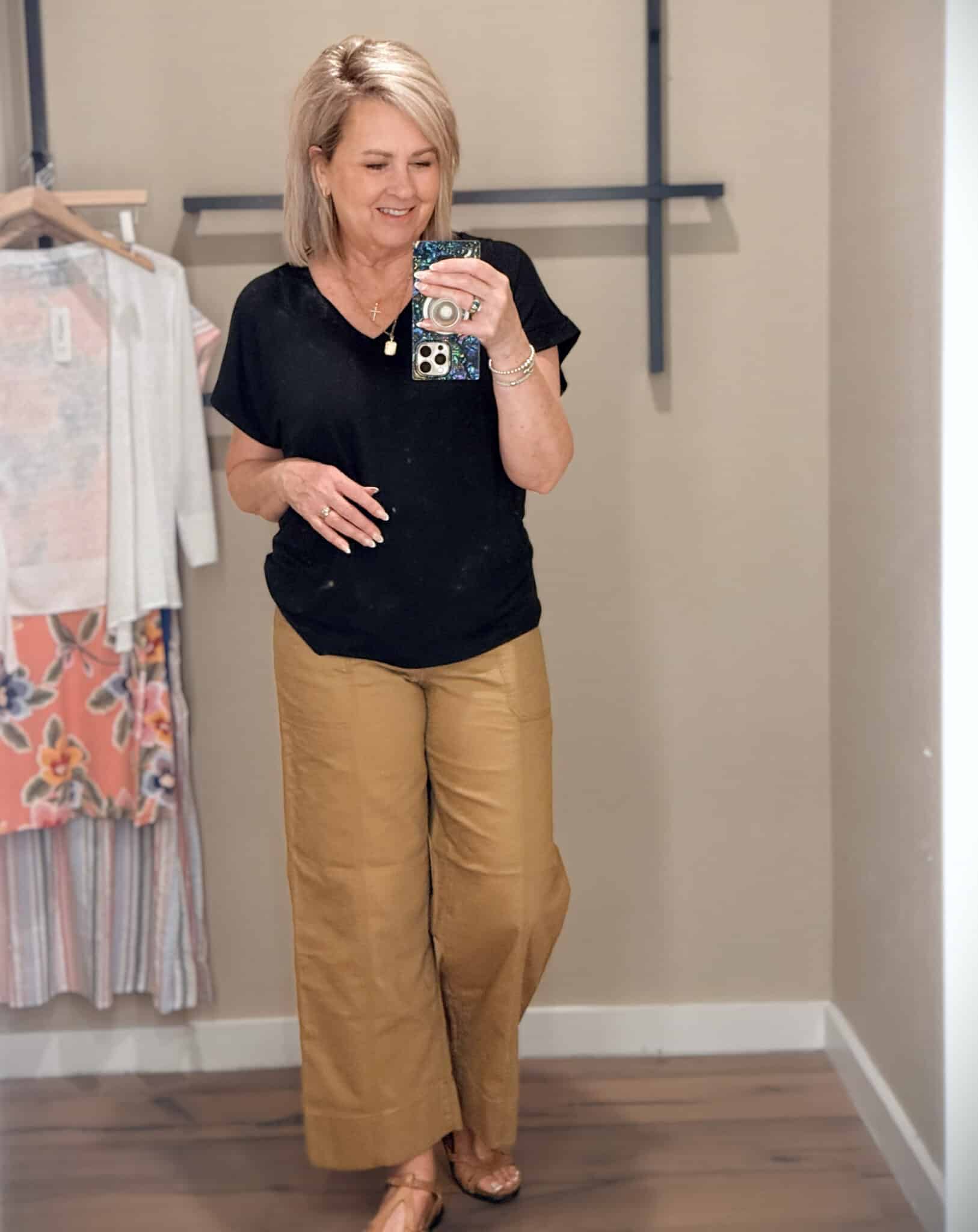 Tania wearing a black v-neck t-shirt and caramel crop pants from Tommy Bahama