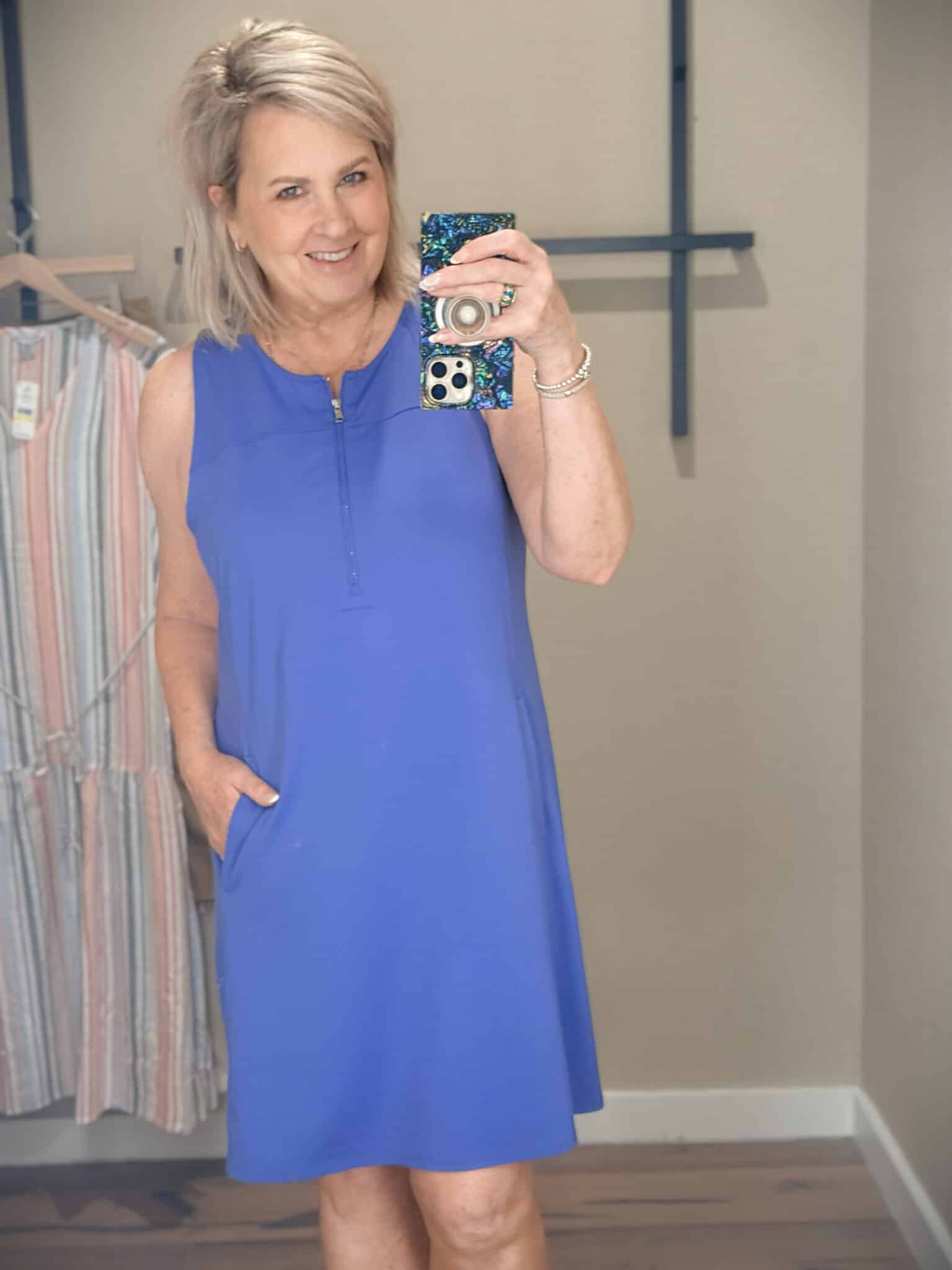 Tania showing the close-up of a blue 1/4 zip tank dress from Tommy Bahama