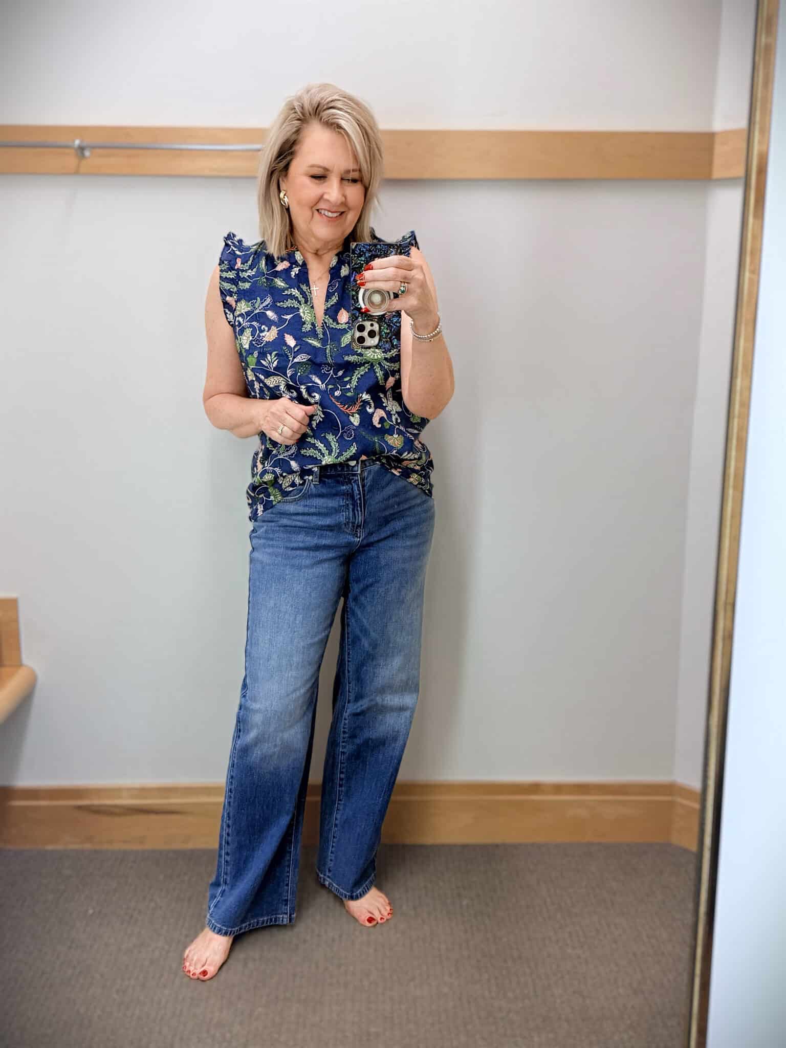 Tania wearing a floral ruffled shell with a pair of trouser jeans from Talbots