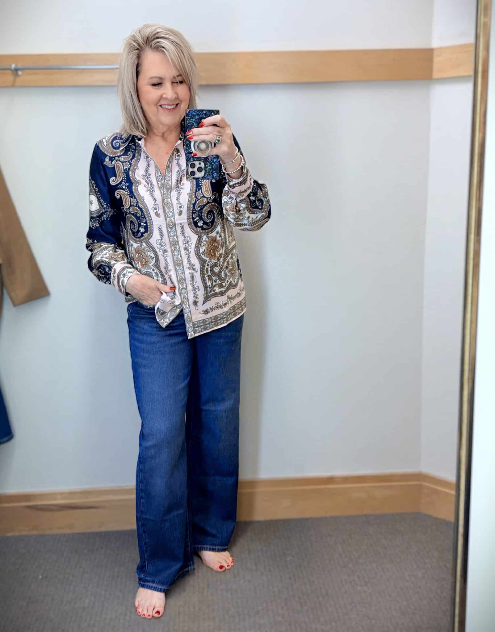 Tania wearing a satin paisley button up shirt with a pair of dark wash trouser jeans from Talbots