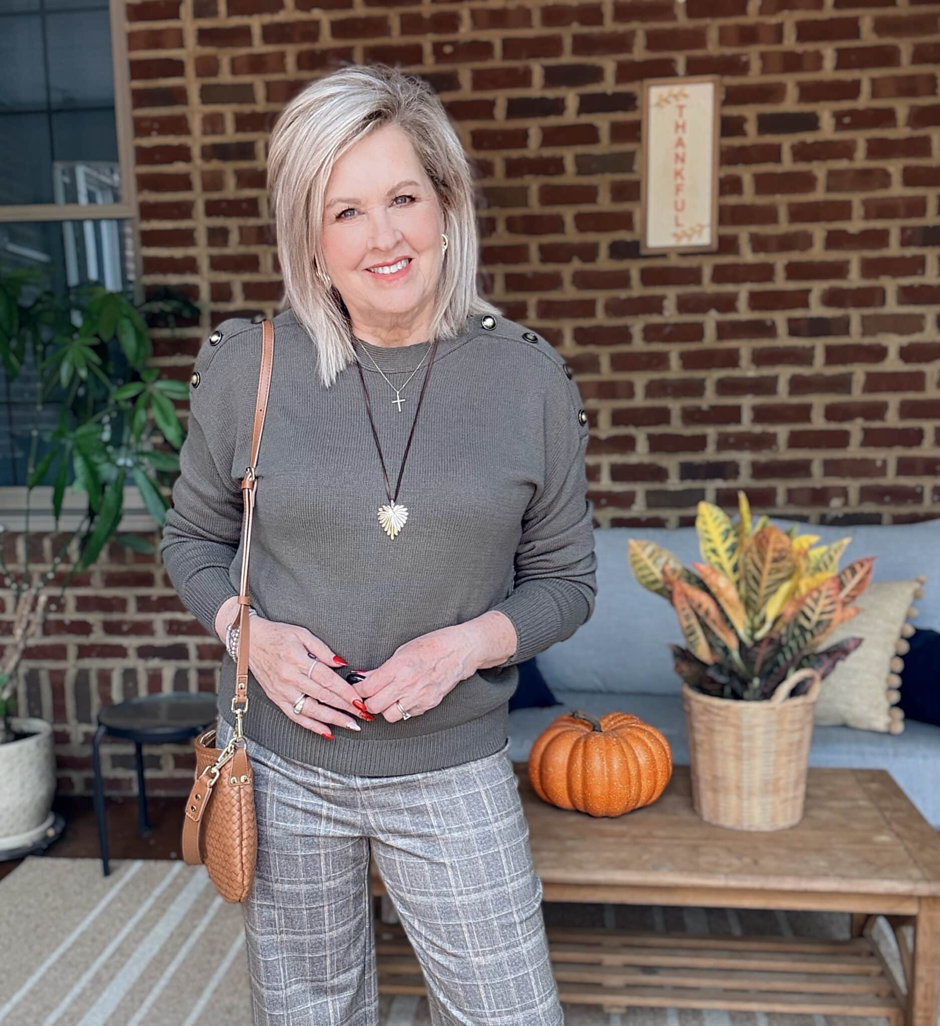 Tania wearing an olive sweater for fall