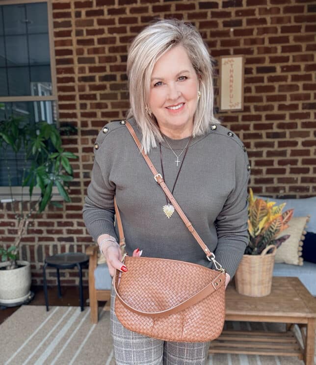 Tania wearing an olive sweater with a Quince crossbody