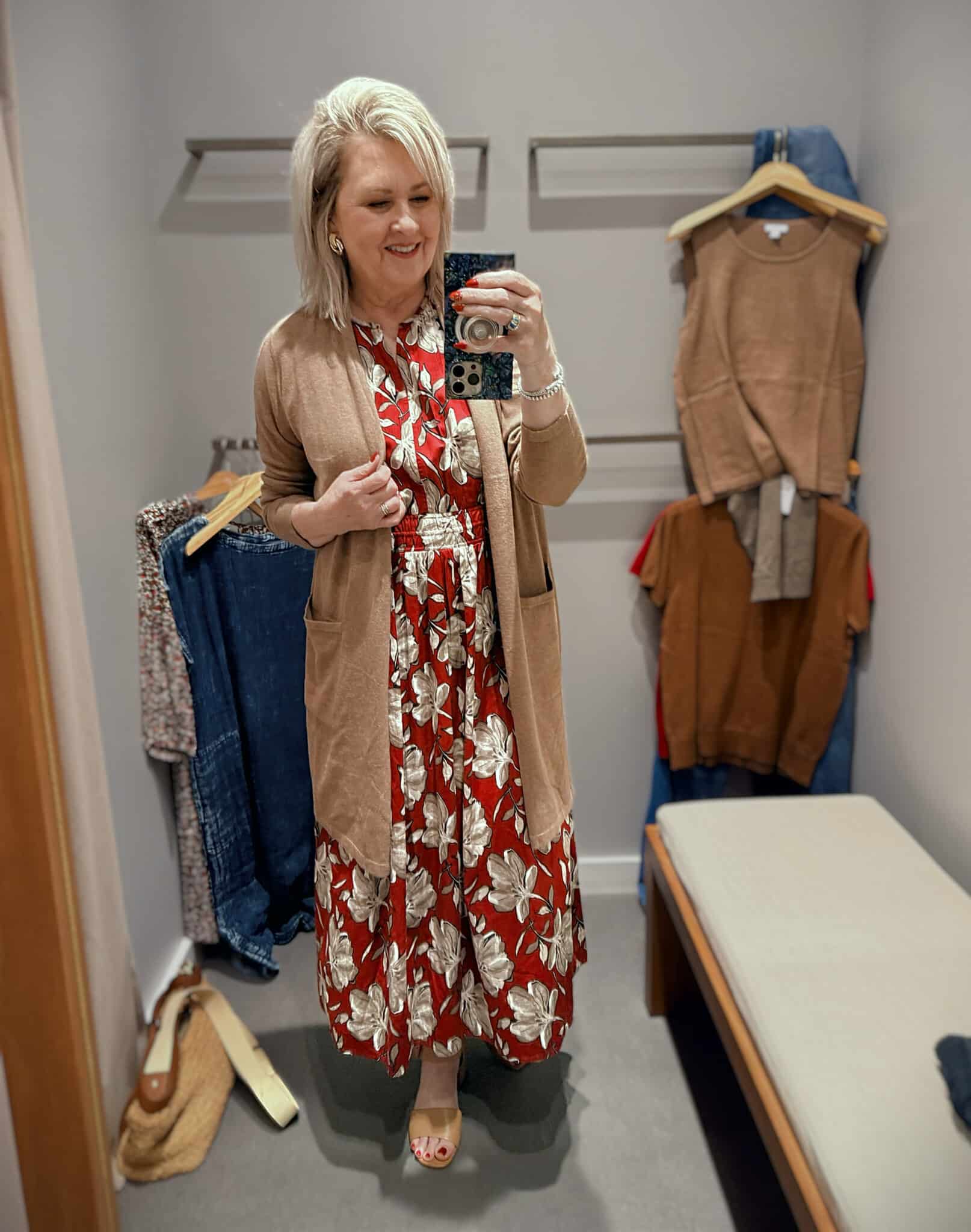 Tania in J.Jill wearing a smocked crimson printed dress with a long cardigan