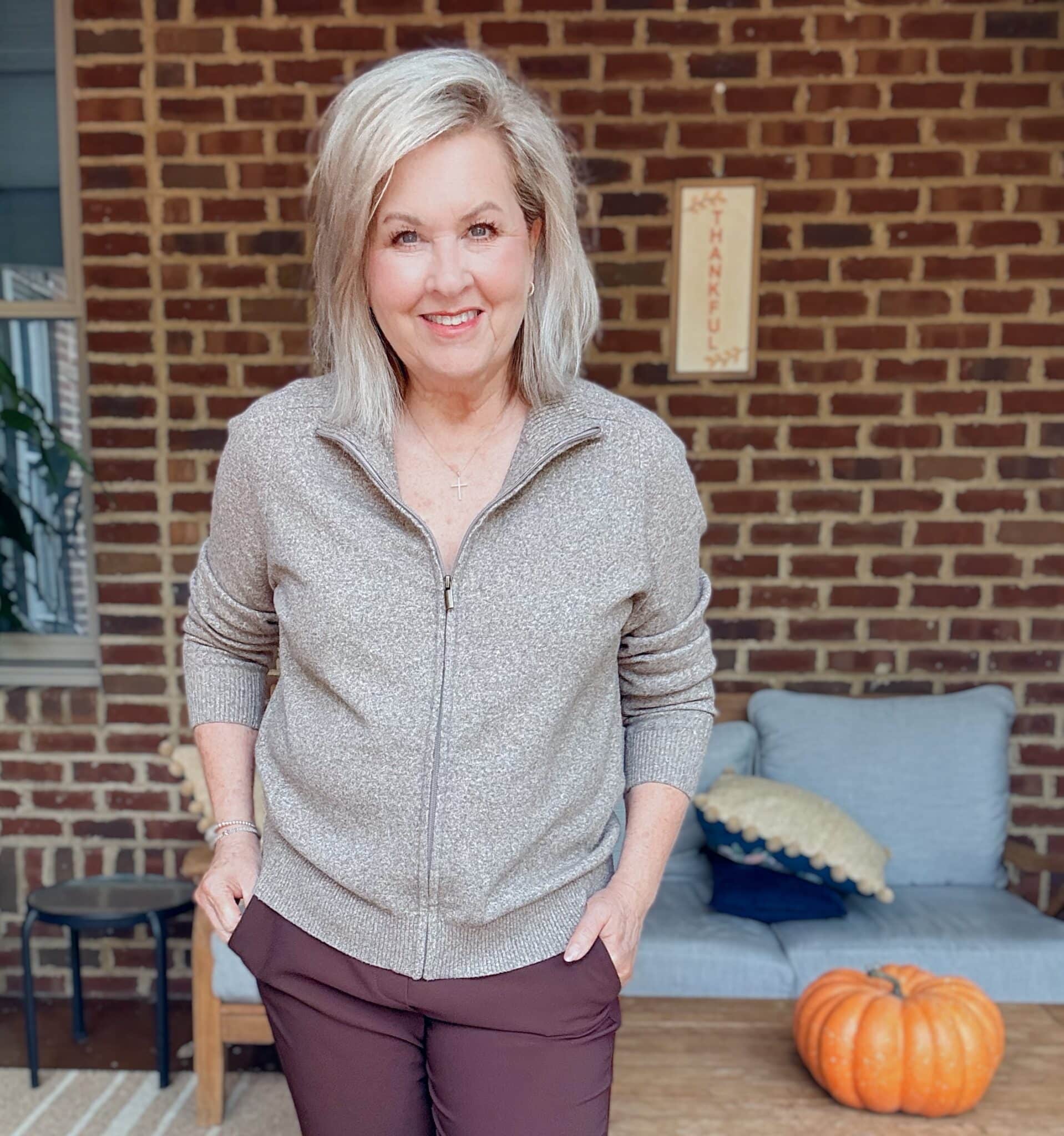 Tania wearing a light brown zip sweater