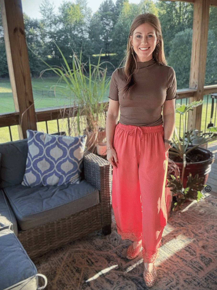 Petite woman wearing a brown ribbed top with rose wide-leg lace-trim pants for fall